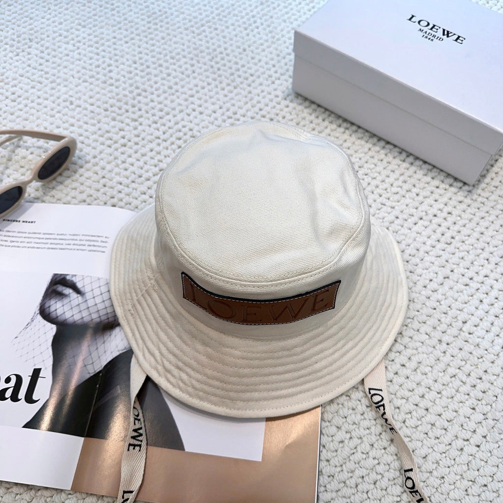 Soft canvas bucket hat with embossed leather logo patch and adjustable chin strap