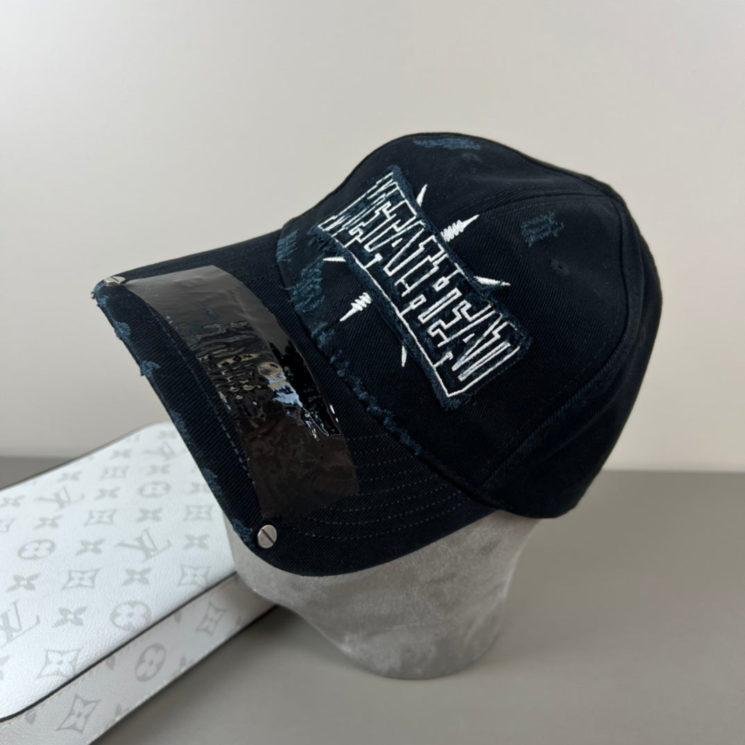 Black distressed cotton cap with metal graphic and glossy shield brim