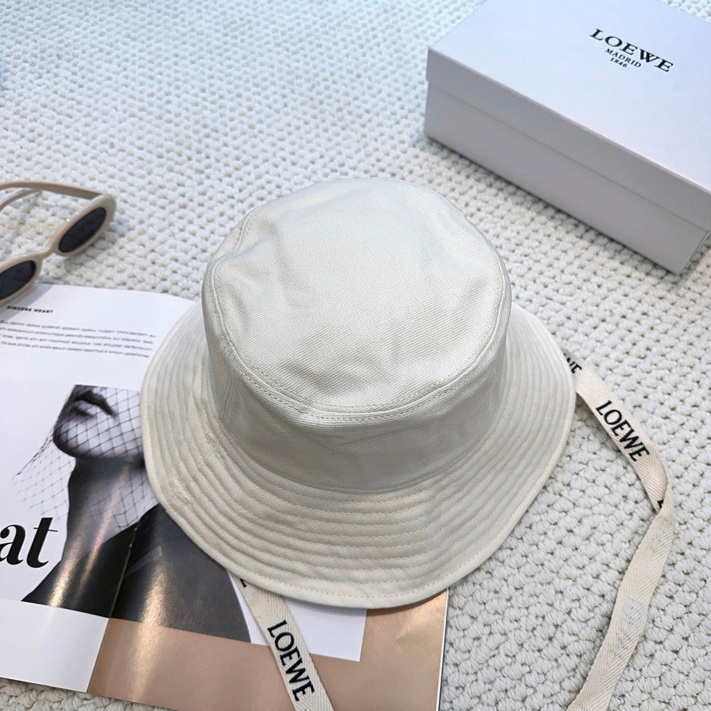 Soft canvas bucket hat with embossed leather logo patch and adjustable chin strap