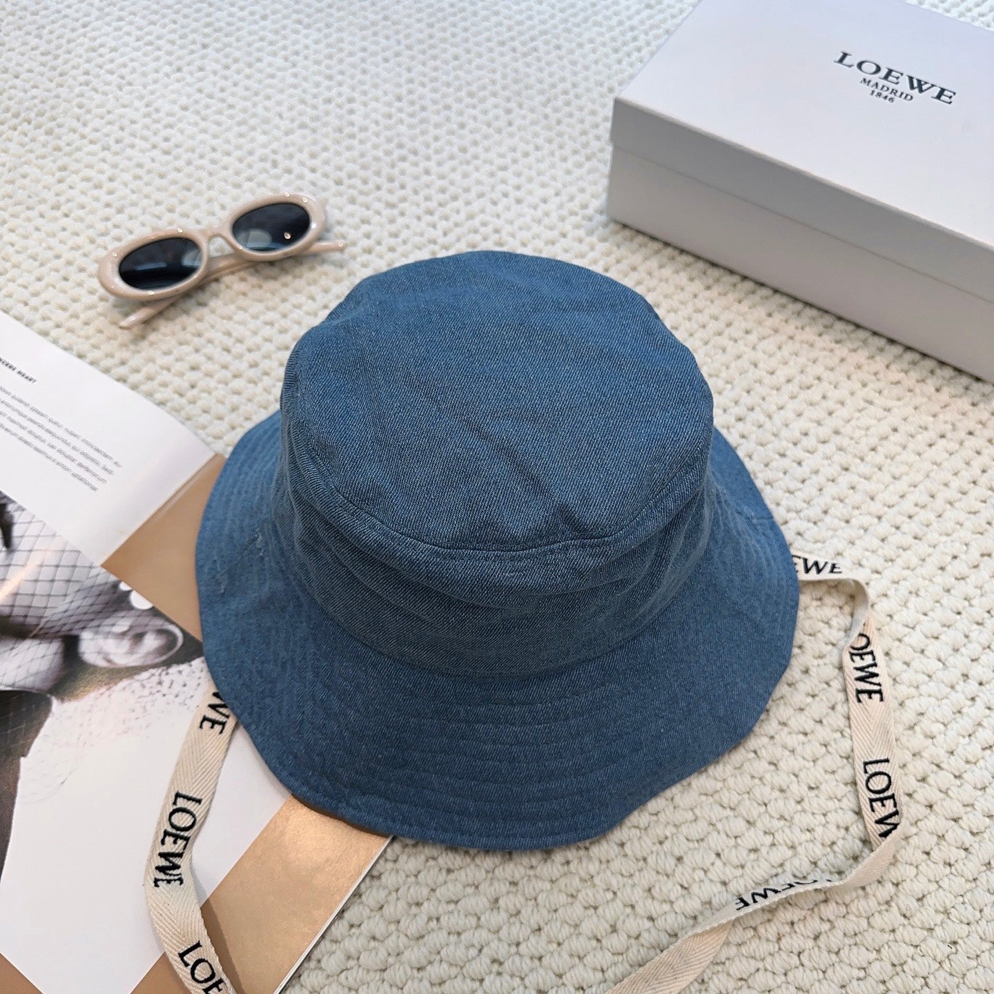 Denim bucket hat with embossed patch and detachable strap