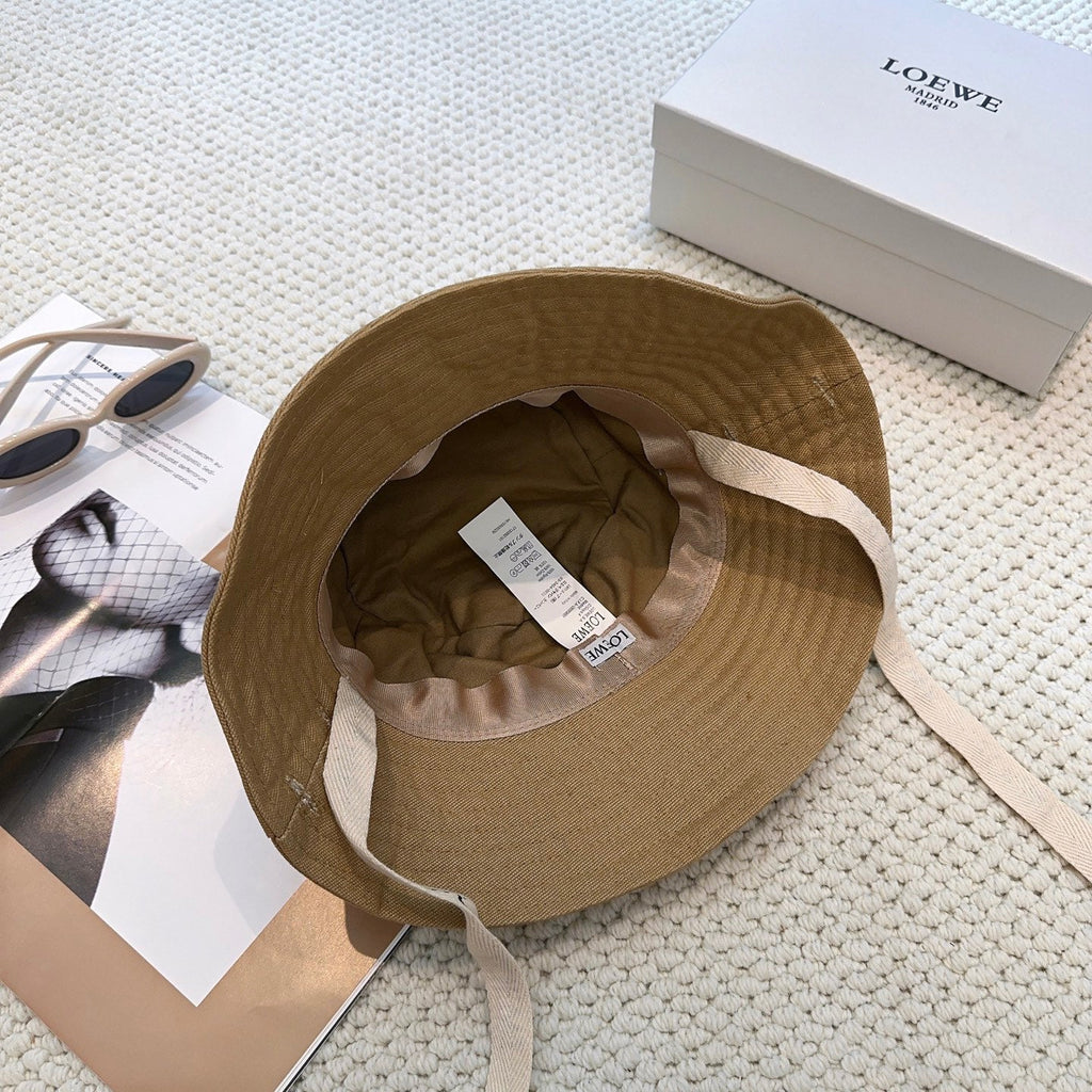 Soft canvas bucket hat with embossed leather logo patch and adjustable chin strap