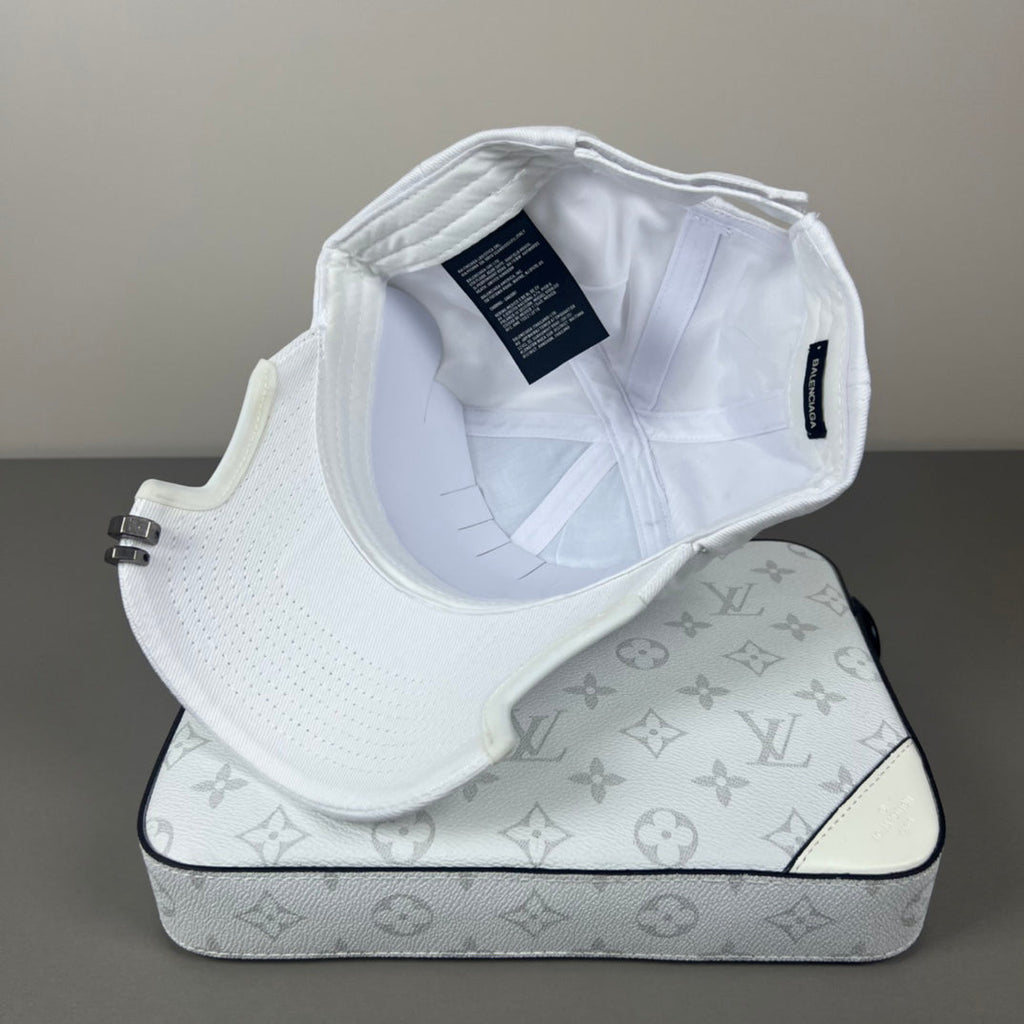 White cotton cap with black graphic embroidery and sculpted brim