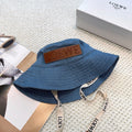 Denim bucket hat with embossed patch and detachable strap