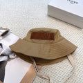 Soft canvas bucket hat with embossed leather logo patch and adjustable chin strap