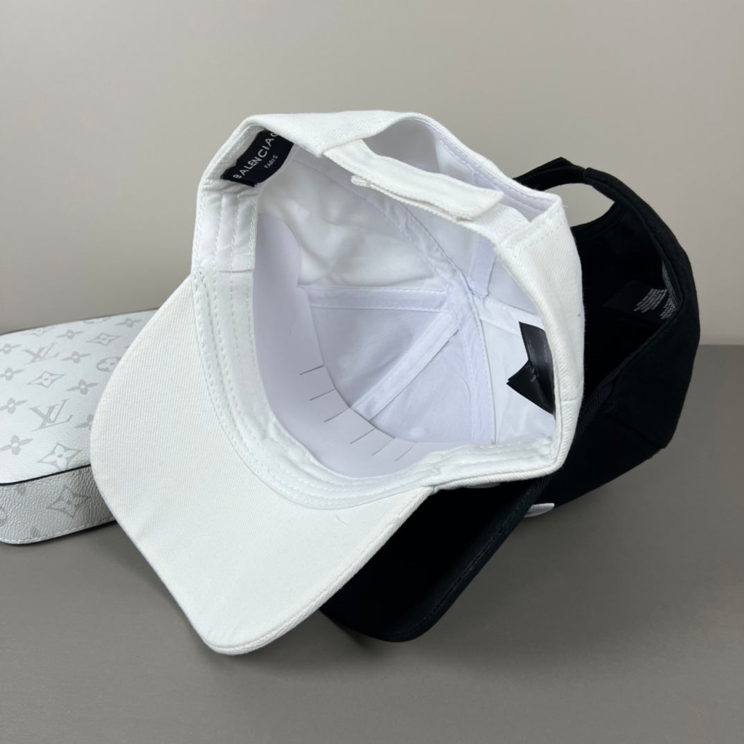 Black cotton cap with white oval emblem embroidery